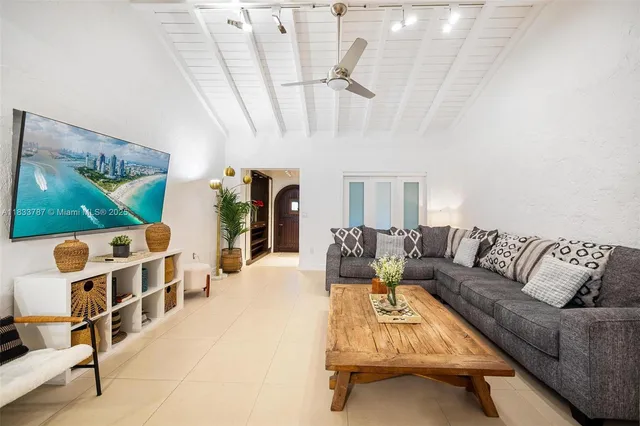 a living room with furniture a rug and white walls