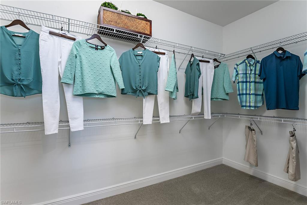 2621 Seychelles Circle, Unit 1806 Naples, FL 34112 - Photo 12 of 25 a view of walk in closet with clothes and shoes