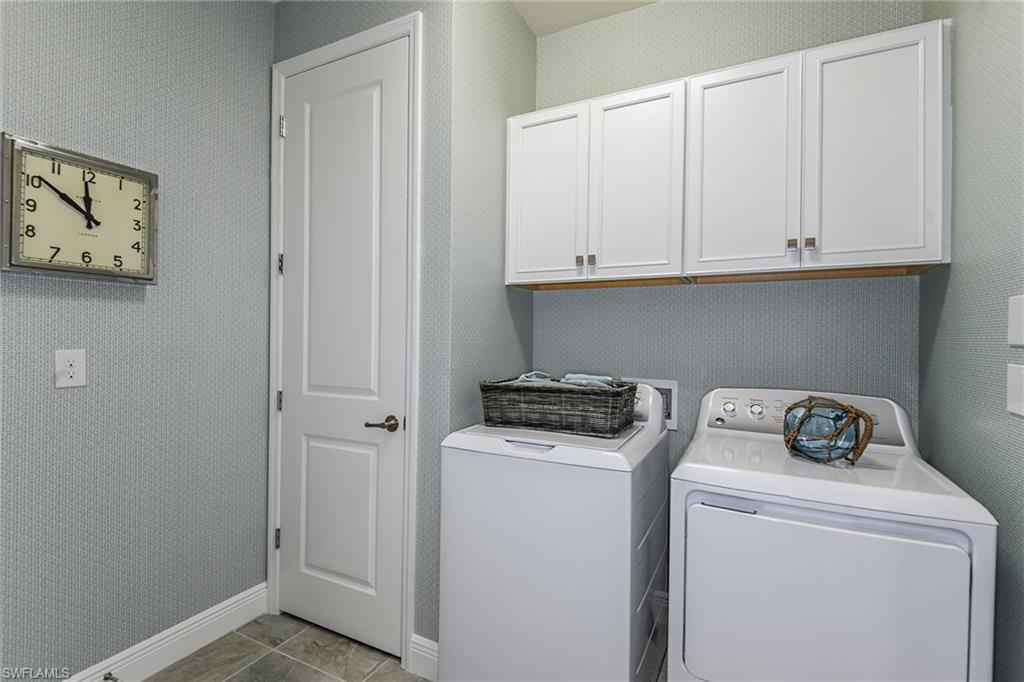 2621 Seychelles Circle, Unit 1806 Naples, FL 34112 - Photo 13 of 25 a utility room with dryer and washer
