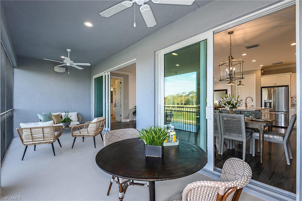 2621 Seychelles Circle, Unit 1806 Naples, FL 34112 - Photo 19 of 25 a living room with furniture and a chandelier