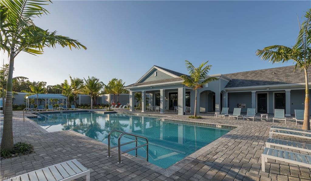 2621 Seychelles Circle, Unit 1806 Naples, FL 34112 - Photo 20 of 25 a view of a house with pool and chairs