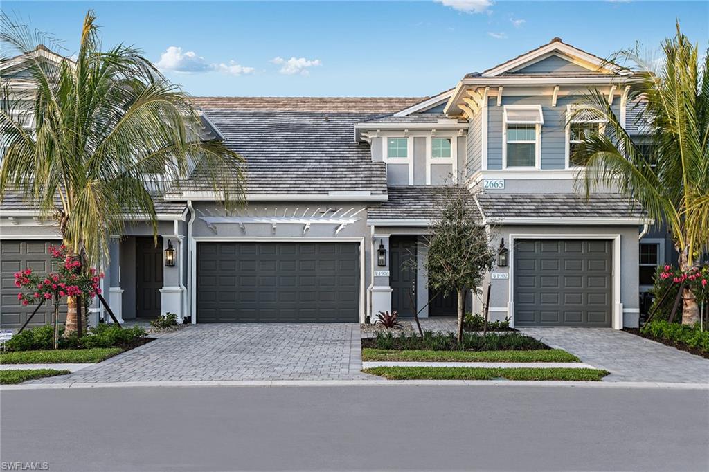 2621 Seychelles Circle, Unit 1806 Naples, FL 34112 - Photo 2 of 25 a front view of a house with a yard and garage