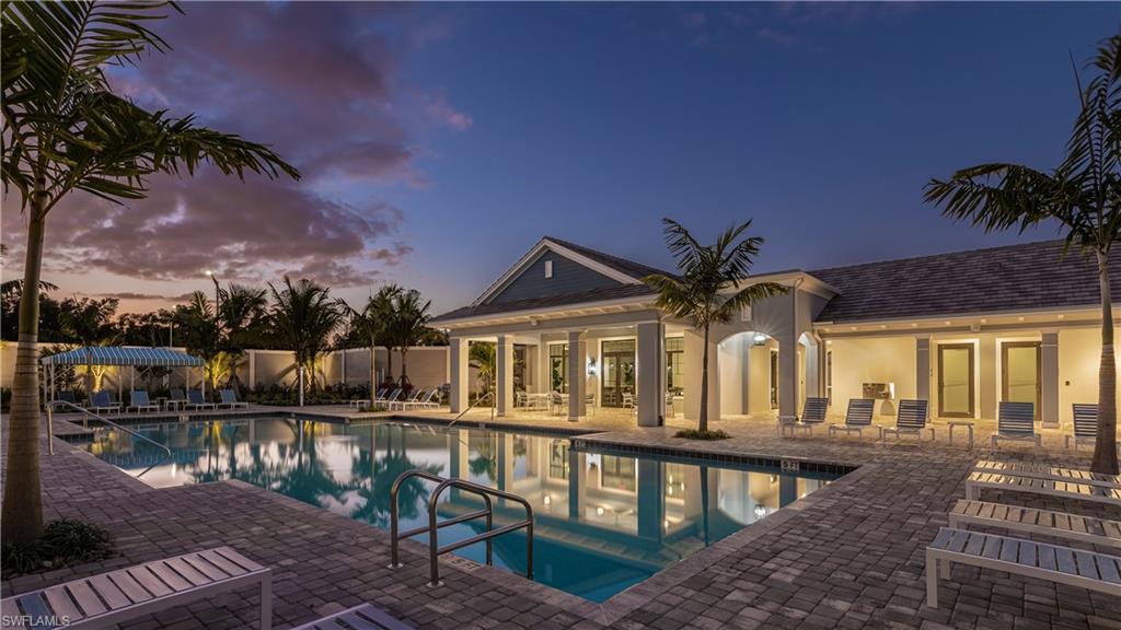 2621 Seychelles Circle, Unit 1806 Naples, FL 34112 - Photo 22 of 25 a front view of house with lake view and a garden