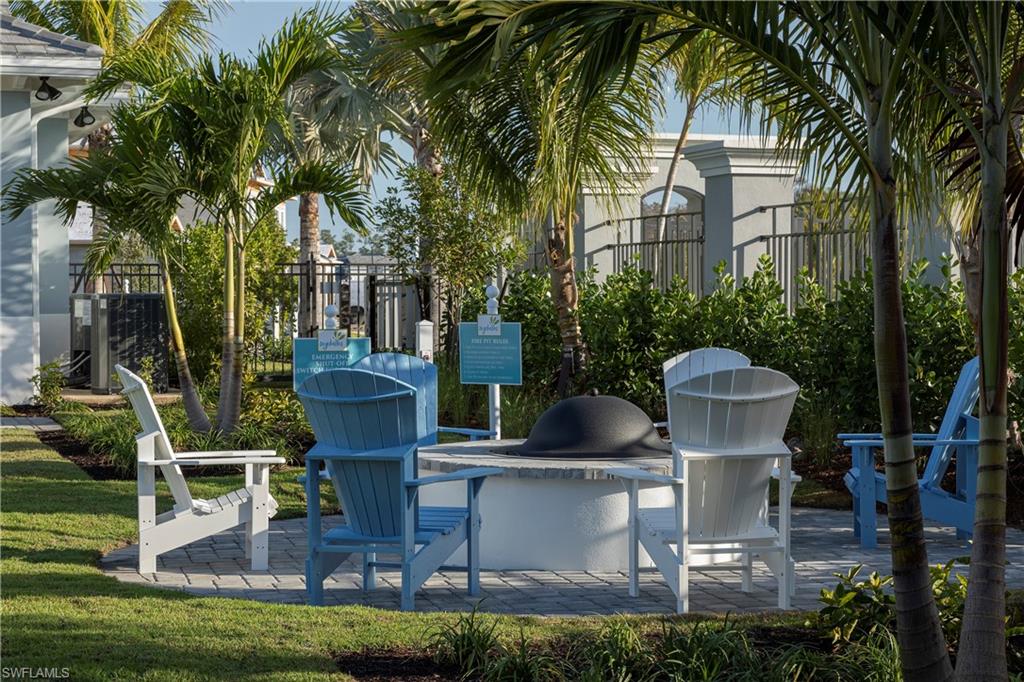 2621 Seychelles Circle, Unit 1806 Naples, FL 34112 - Photo 23 of 25 a view of a house with backyard water fountain and sitting area