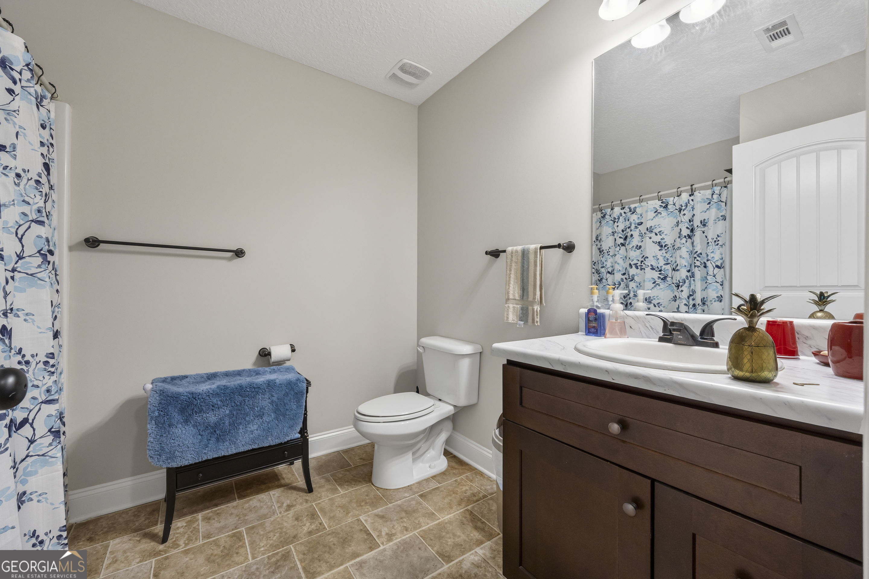 717 Oconee Lane Commerce, GA 30529 - Photo 42 of 57 a bathroom with a sink toilet a mirror and vanity