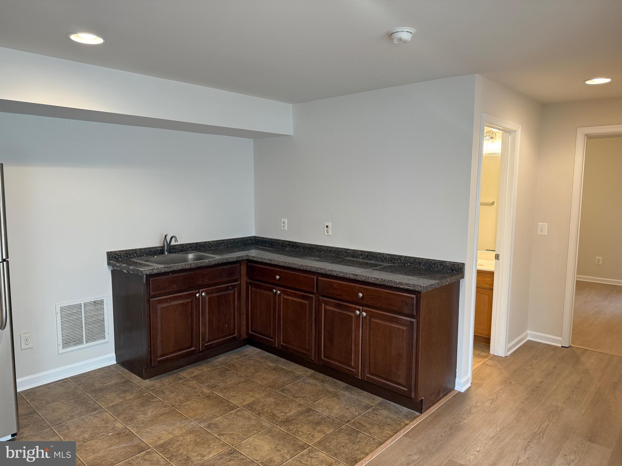 6231 Glen Wood Loop Manassas, VA 20112 - Photo 15 of 18 a kitchen with a sink and a refrigerator
