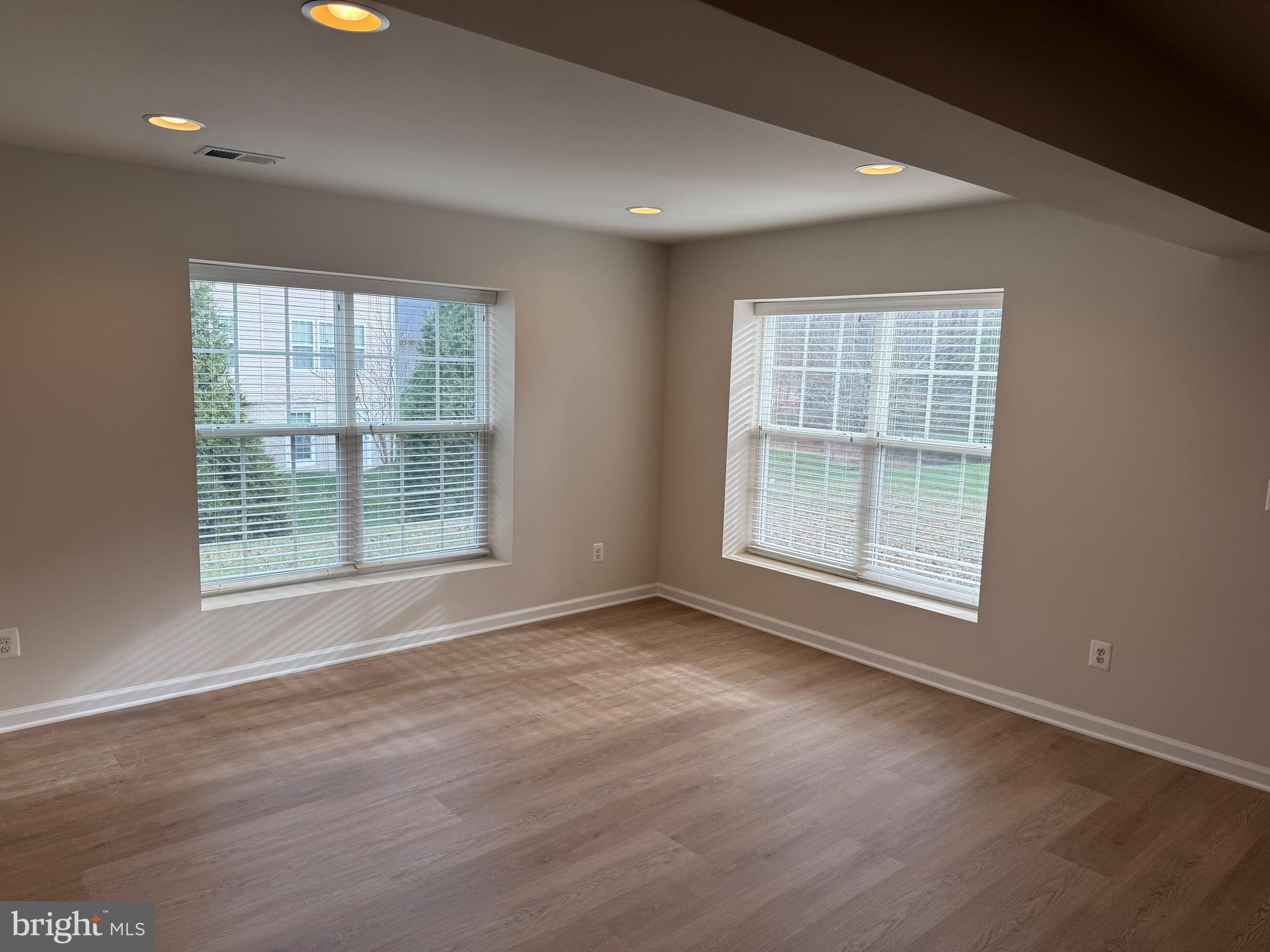 6231 Glen Wood Loop Manassas, VA 20112 - Photo 16 of 18 an empty room with wooden floor and windows