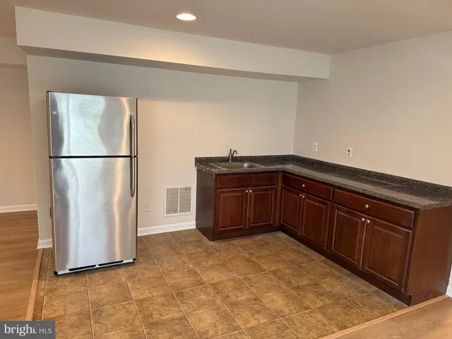 a view of a refrigerator in kitchen and wooden floor
