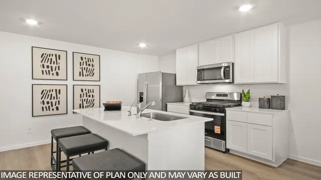 a kitchen with stainless steel appliances kitchen island granite countertop a sink and a stove top oven