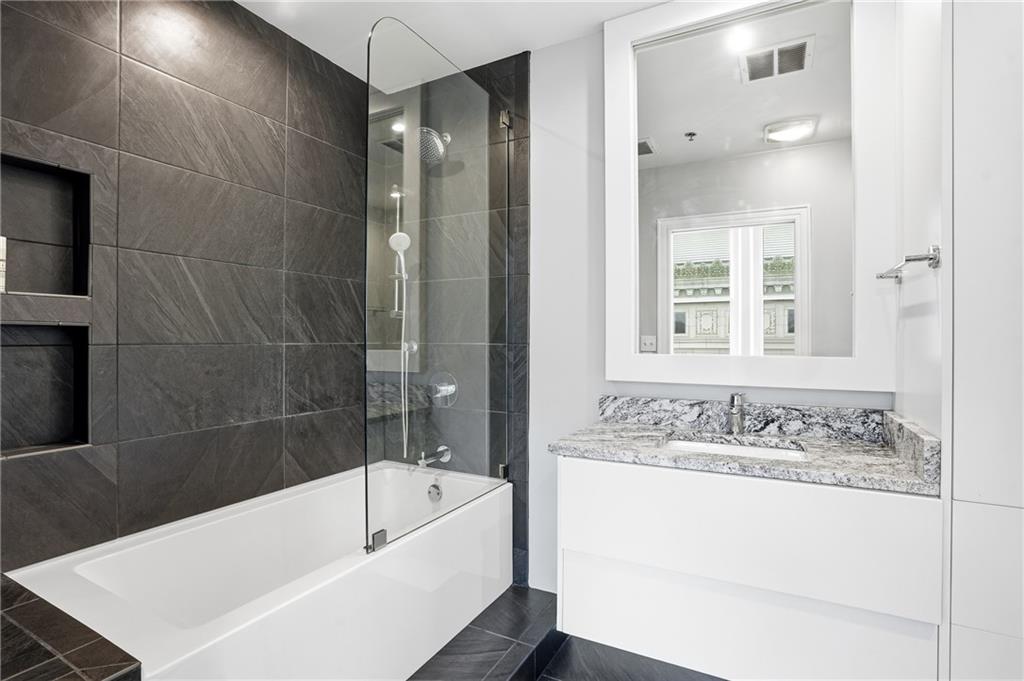 57 Forsyth Street Northwest, Unit 5D Atlanta, GA 30303 - Photo 18 of 28 a bathroom with a bathtub and a sink