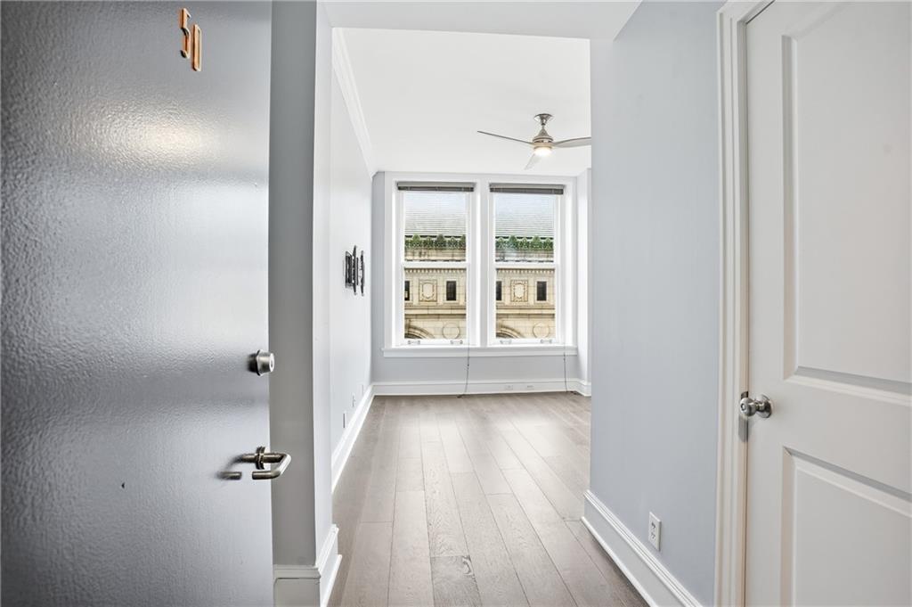 57 Forsyth Street Northwest, Unit 5D Atlanta, GA 30303 - Photo 23 of 28 a view of a hallway with wooden floor and closet