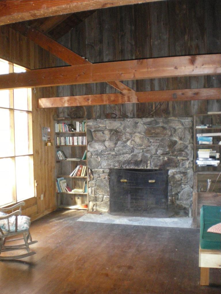 88 Webster Road Tyringham, MA 01264 - Photo 2 of 10 a room with fireplace and a wooden floor