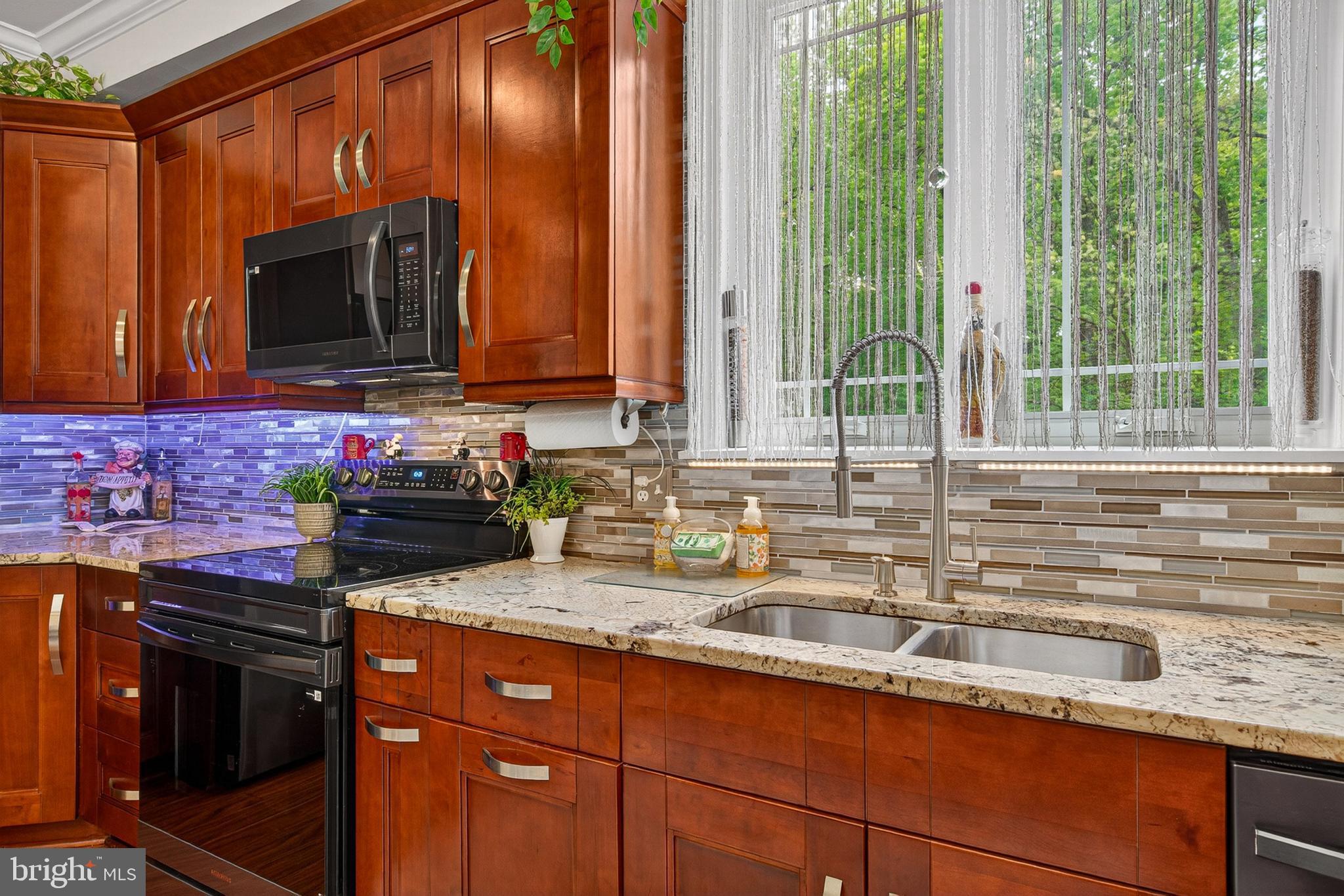 4603 Lathe Road Owings Mills, MD 21117 - Photo 21 of 86 a kitchen with granite countertop a sink a stove and a microwave