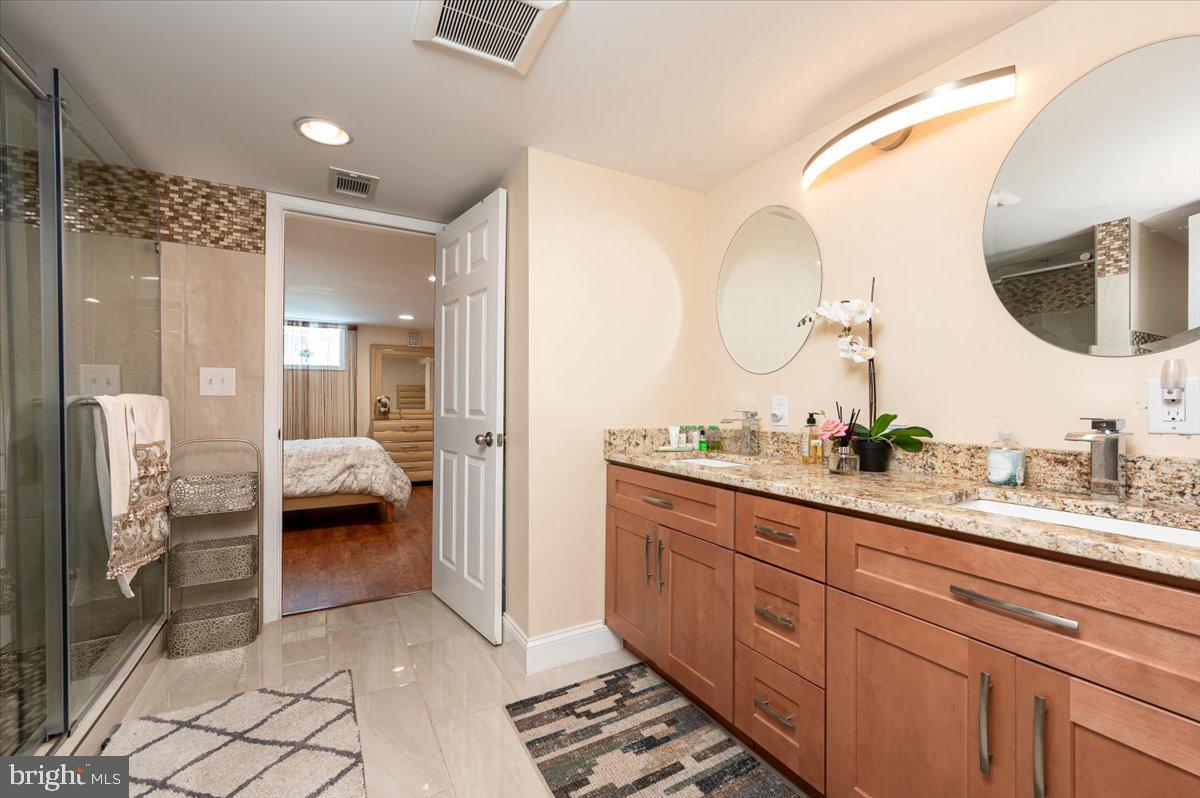4603 Lathe Road Owings Mills, MD 21117 - Photo 58 of 86 a spacious bathroom with a double vanity sink and a mirror