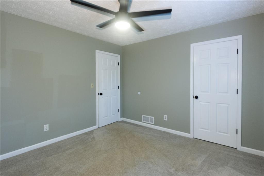 374 McGiboney Road Covington, GA 30016 - Photo 14 of 29 an empty room with closet and fan