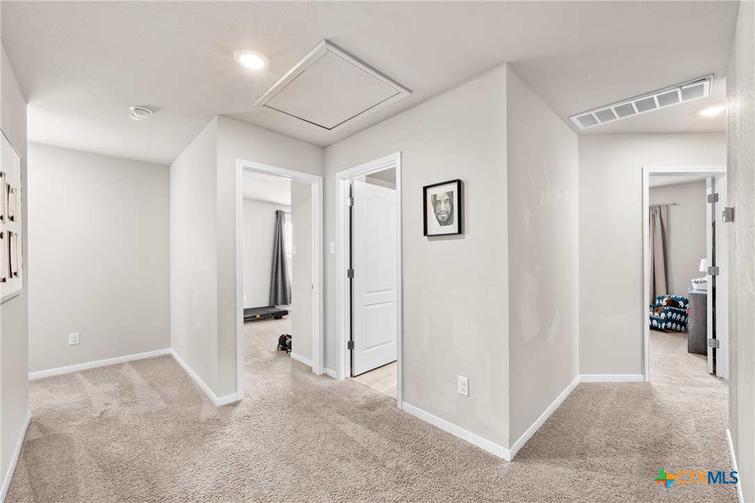 7468 Mossy Ridge Lane Temple, TX 76502 - Photo 17 of 38 a view of a hallway with closet and bathroom