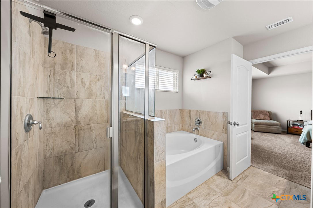 7468 Mossy Ridge Lane Temple, TX 76502 - Photo 21 of 38 a bathroom with a bathtub and a shower