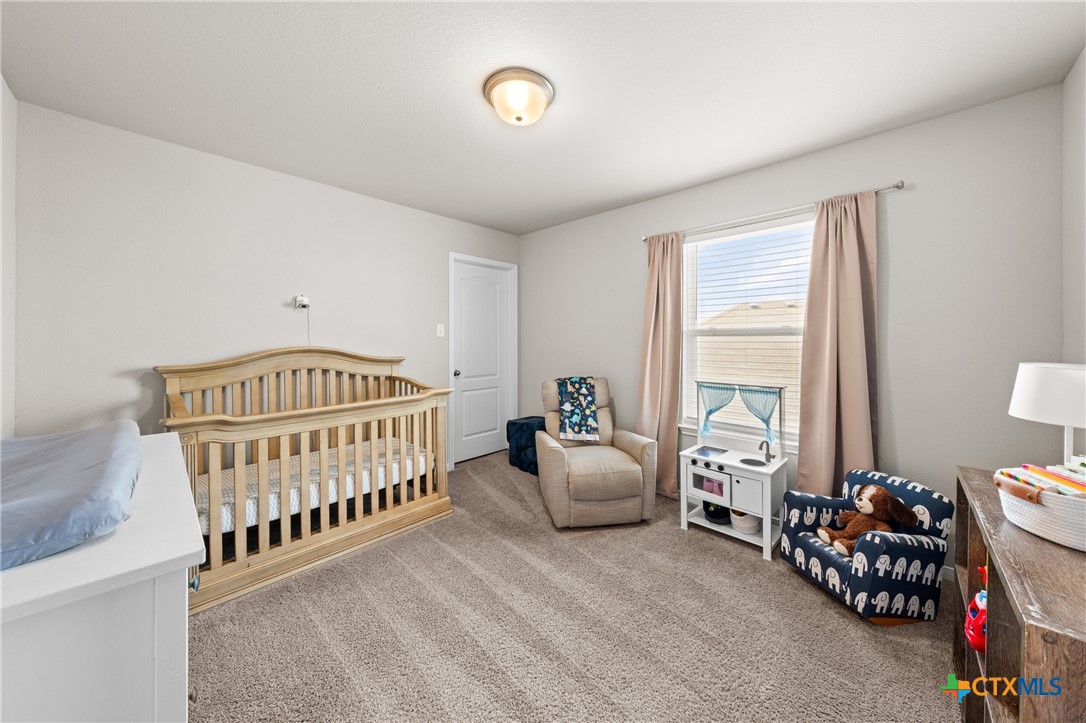 7468 Mossy Ridge Lane Temple, TX 76502 - Photo 25 of 38 a bedroom with furniture and a bed