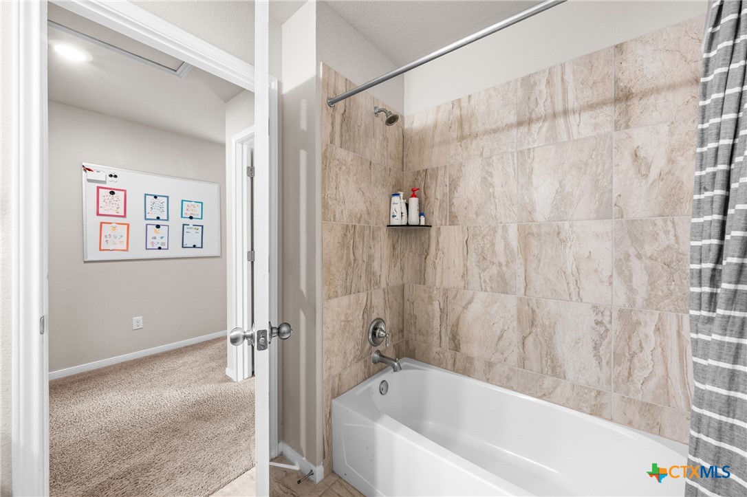 7468 Mossy Ridge Lane Temple, TX 76502 - Photo 28 of 38 a bathroom with a bathtub and shower