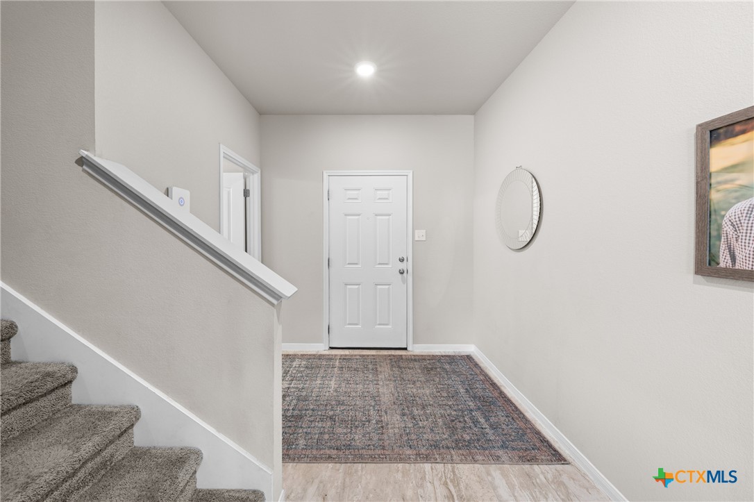 7468 Mossy Ridge Lane Temple, TX 76502 - Photo 4 of 38 a view of a livingroom with wooden floor and staircase