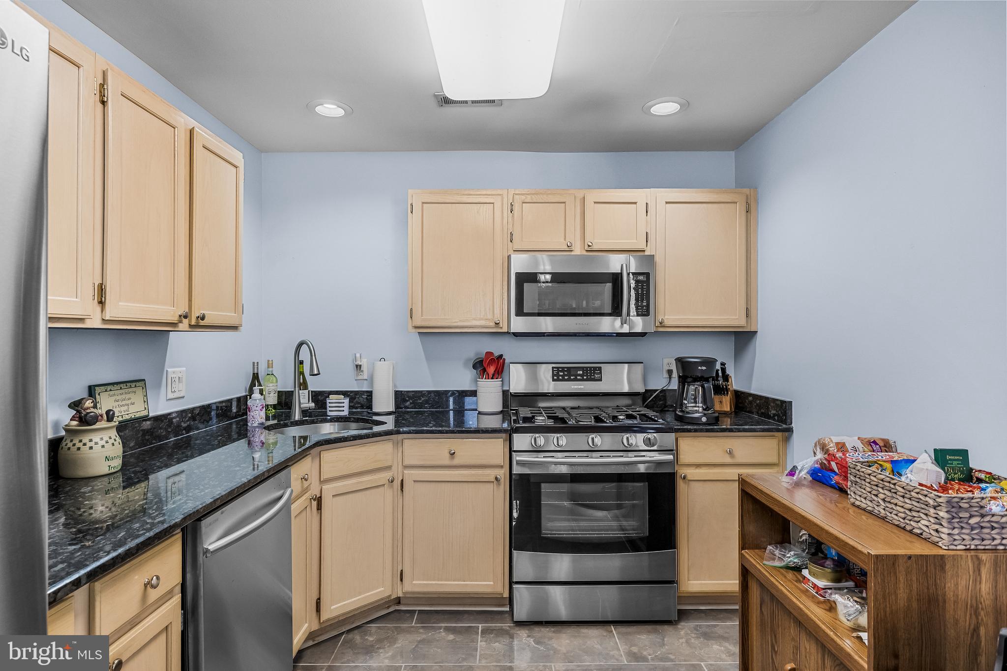 203 Quail Road Marlton, NJ 08053 - Photo 9 of 27 a kitchen with stainless steel appliances granite countertop a stove a sink and a microwave