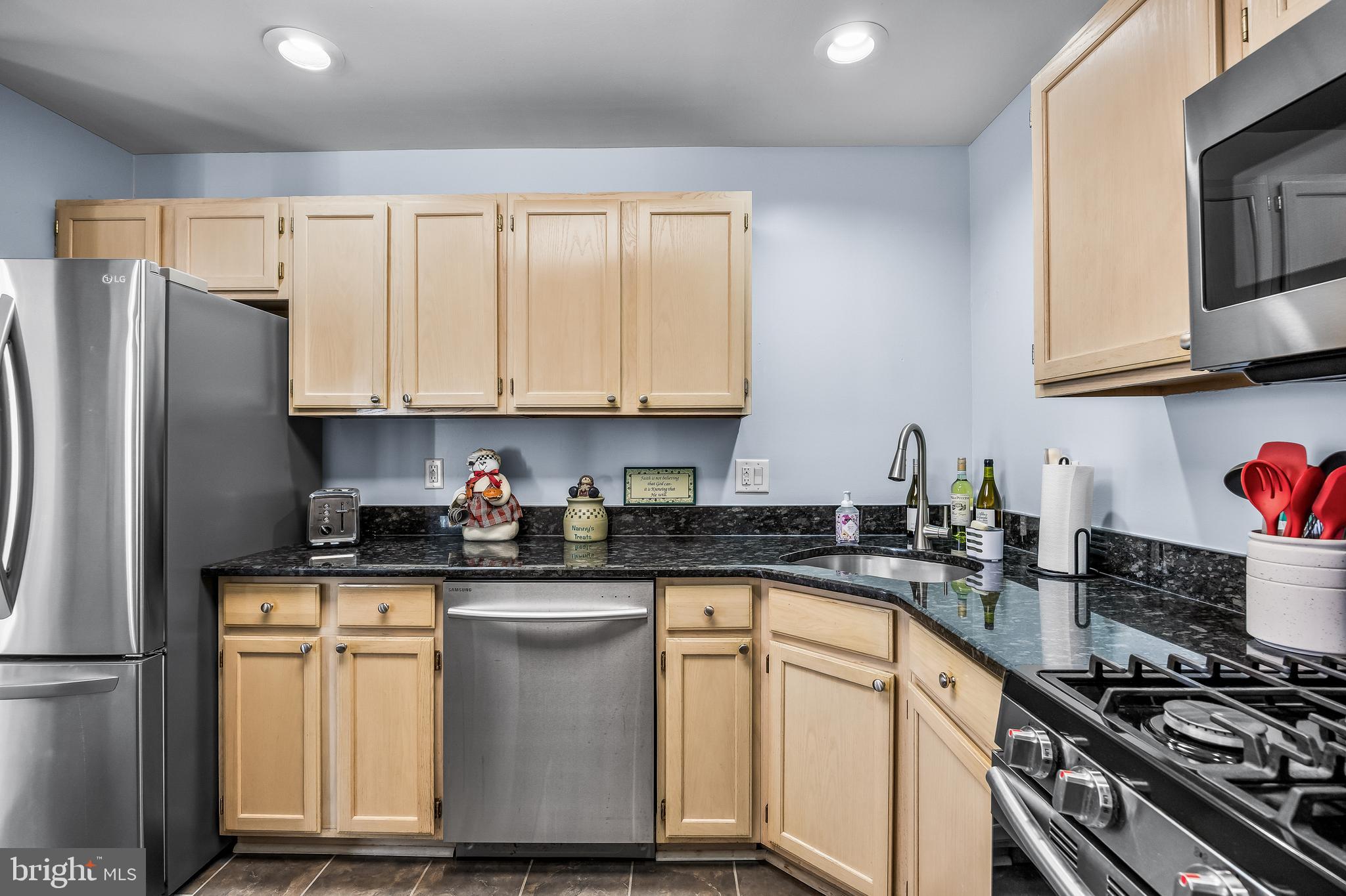 203 Quail Road Marlton, NJ 08053 - Photo 11 of 27 a kitchen with granite countertop a stove sink and cabinets