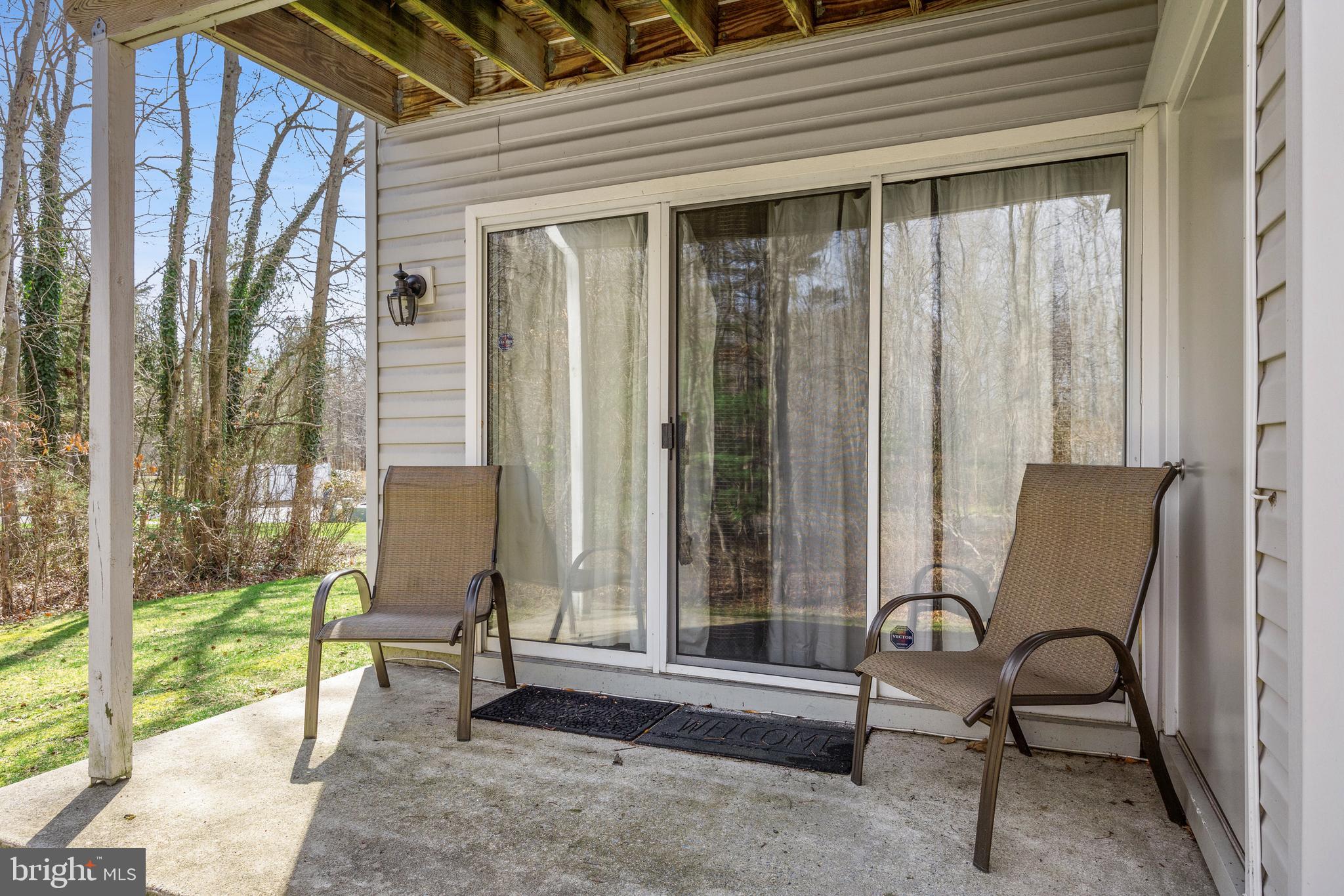 203 Quail Road Marlton, NJ 08053 - Photo 20 of 27 a view of a balcony with chairs and floor to ceiling window