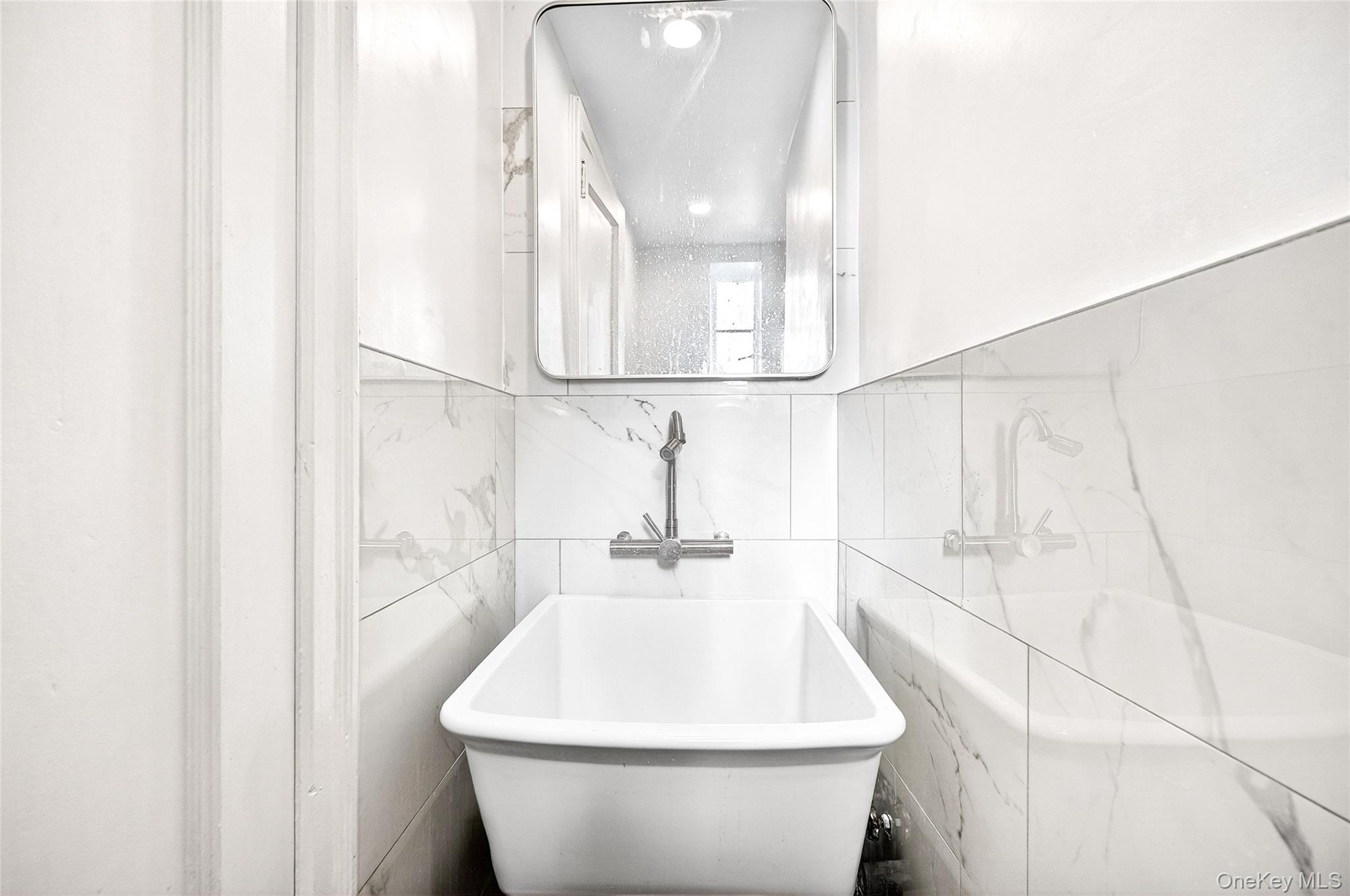 1458 Rowland Street Bronx, NY 10461 - Photo 21 of 49 Full bath with a freestanding tub and tile walls