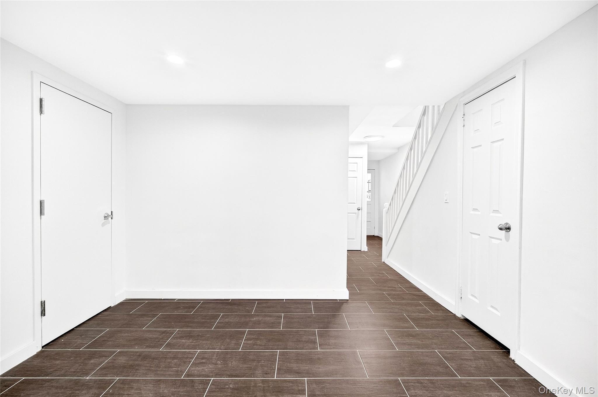 1458 Rowland Street Bronx, NY 10461 - Photo 24 of 49 Empty room with recessed lighting and stairs