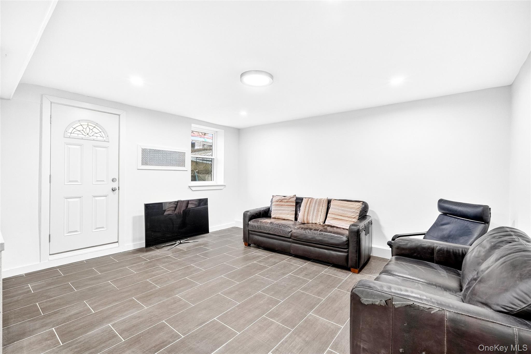 1458 Rowland Street Bronx, NY 10461 - Photo 30 of 49 Living area featuring recessed lighting and wood tiled floors