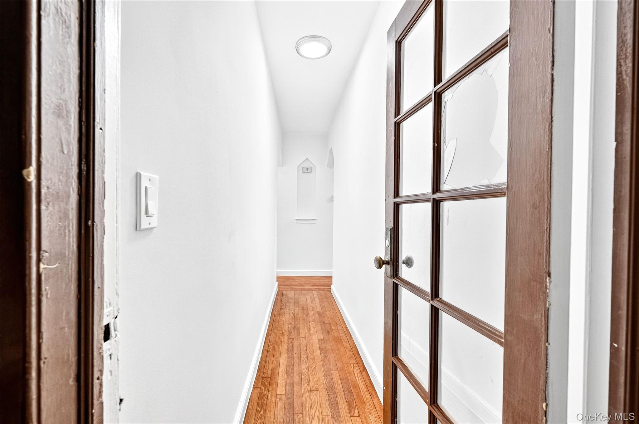 1458 Rowland Street Bronx, NY 10461 - Photo 32 of 49 Corridor featuring baseboards and light wood-style flooring
