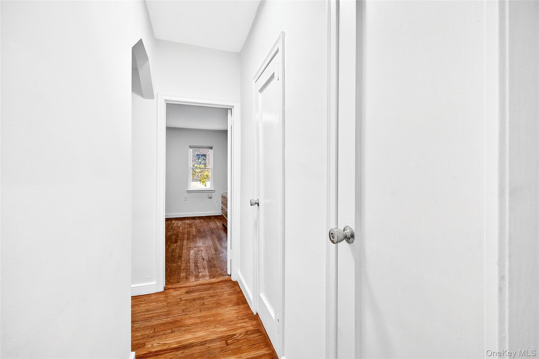 1458 Rowland Street Bronx, NY 10461 - Photo 33 of 49 Corridor featuring light wood-style floors and baseboards