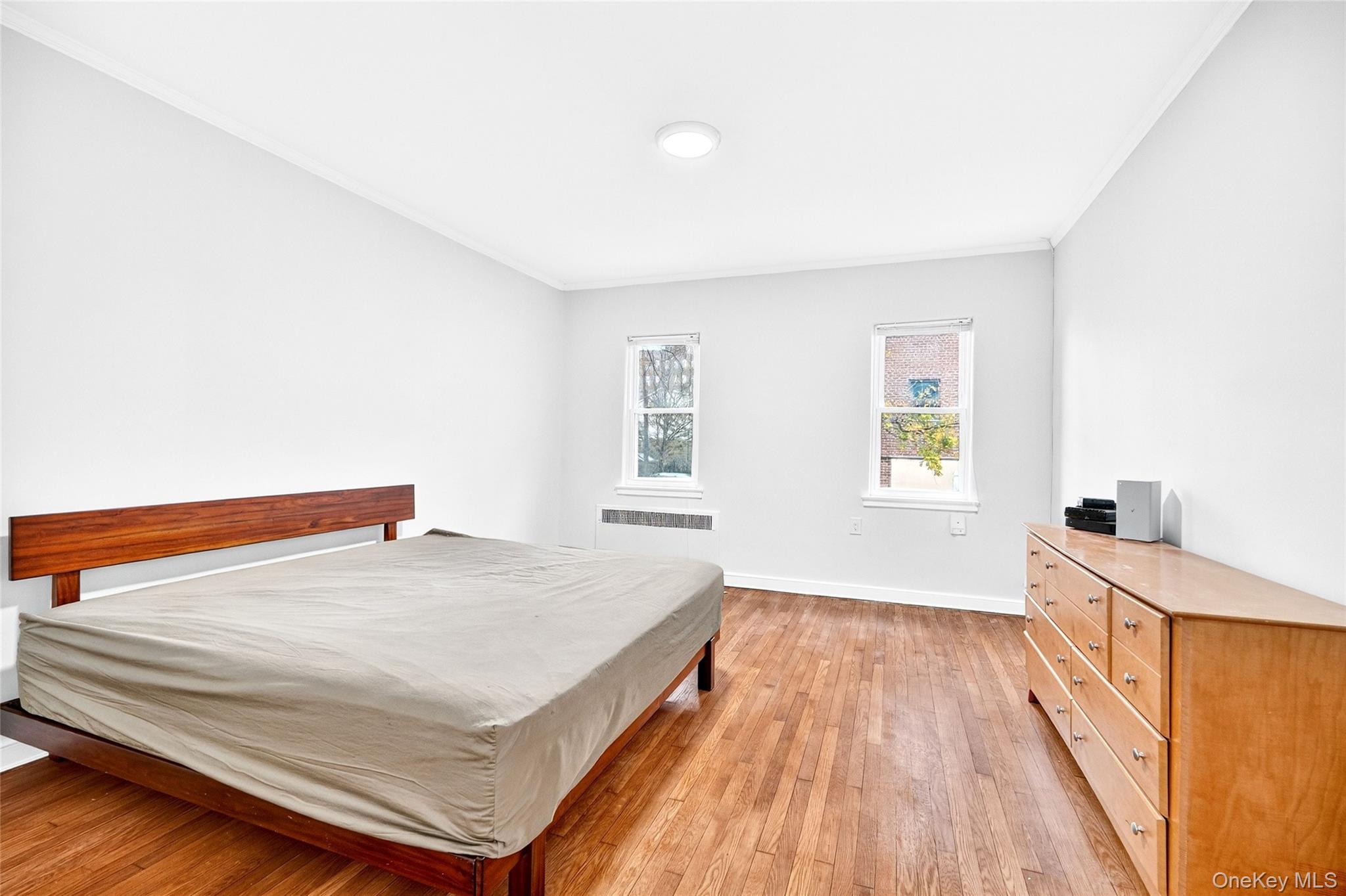 1458 Rowland Street Bronx, NY 10461 - Photo 34 of 49 Bedroom featuring light wood-type flooring and ornamental molding