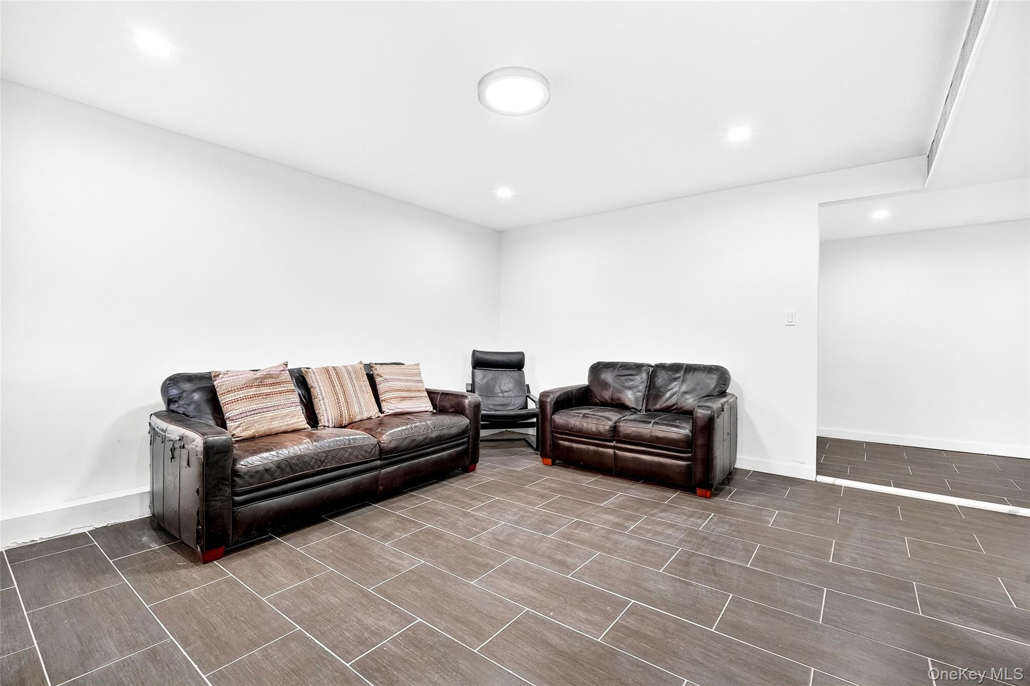 1458 Rowland Street Bronx, NY 10461 - Photo 9 of 49 Living area with recessed lighting and wood tiled floors