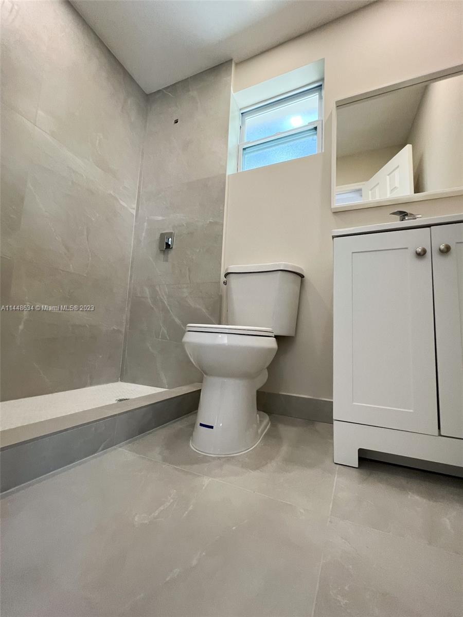 Pinewood Miami, FL 33167 - Photo 14 of 31 a bathroom with a toilet sink and mirror