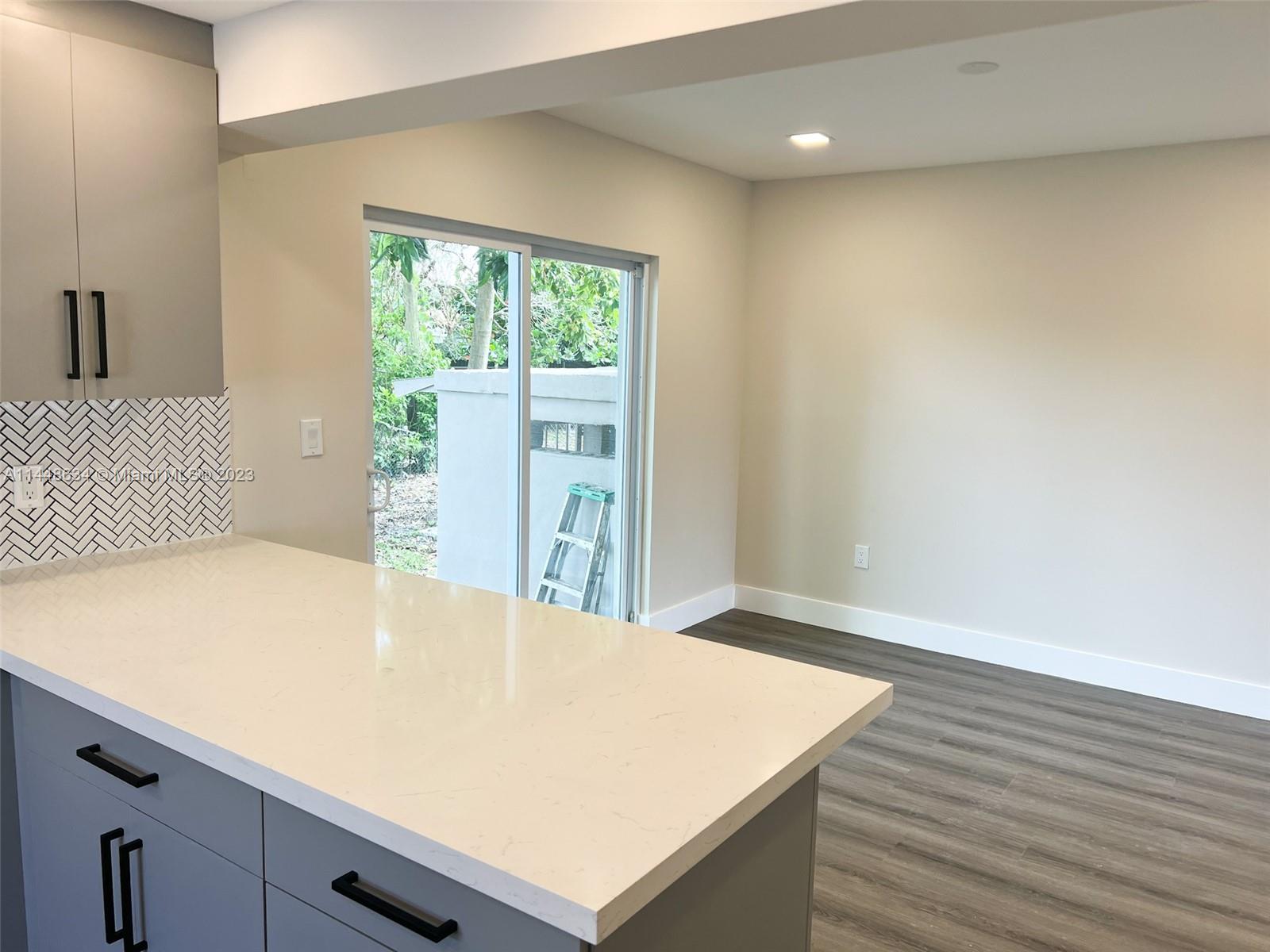 Pinewood Miami, FL 33167 - Photo 15 of 31 a room with a bed and a window