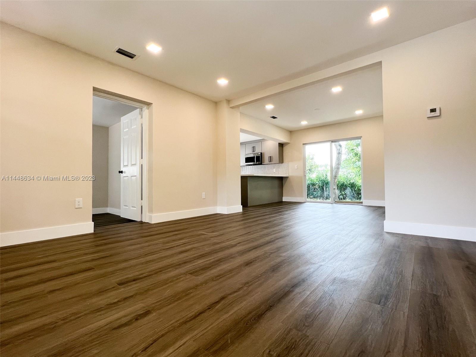 Pinewood Miami, FL 33167 - Photo 17 of 31 a view of empty room with wooden floor and window