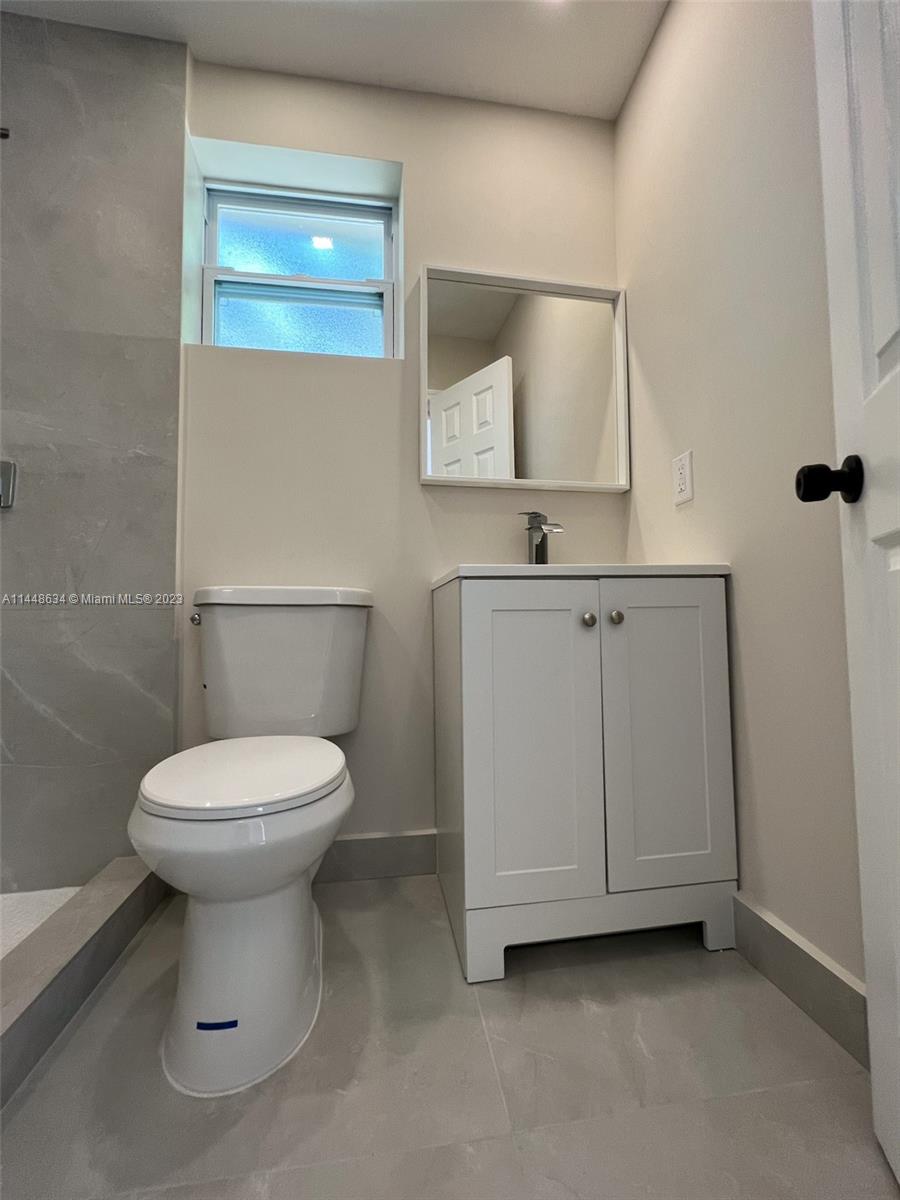 Pinewood Miami, FL 33167 - Photo 20 of 31 a bathroom with a toilet sink and mirror