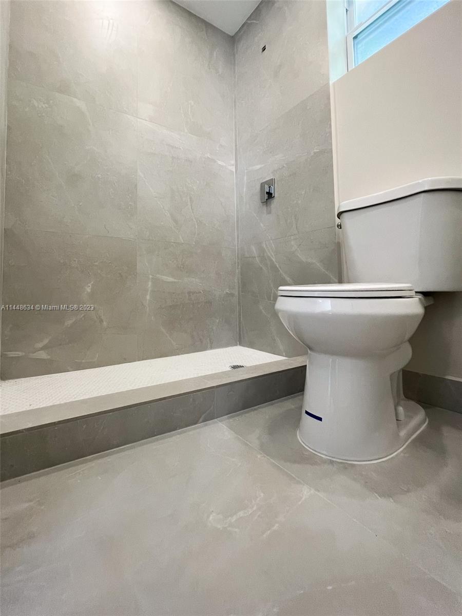 Pinewood Miami, FL 33167 - Photo 21 of 31 a bathroom with a toilet and a bathtub