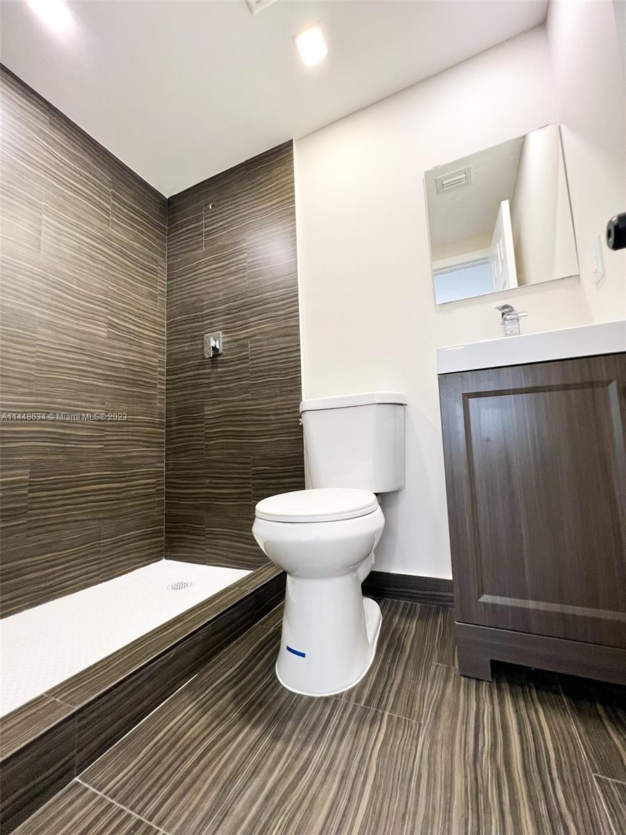 Pinewood Miami, FL 33167 - Photo 22 of 31 a bathroom with a sink and a toilet