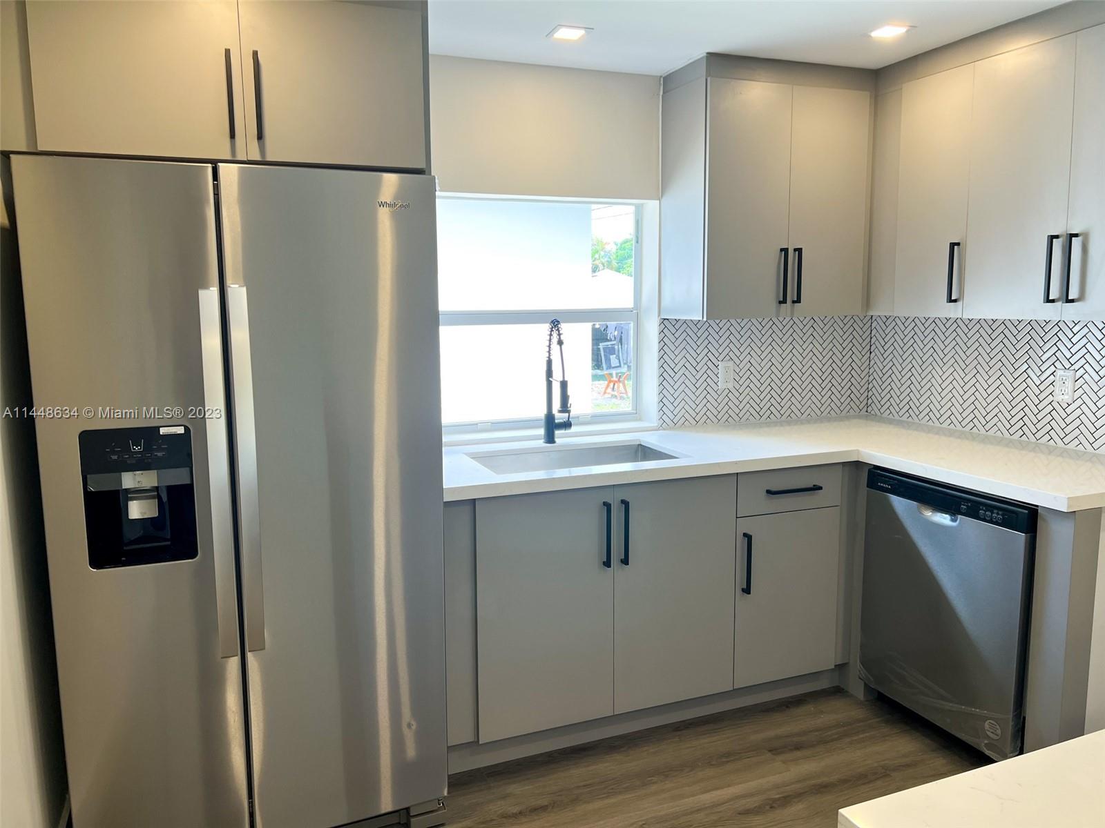 Pinewood Miami, FL 33167 - Photo 27 of 31 a kitchen with stainless steel appliances a refrigerator and a sink