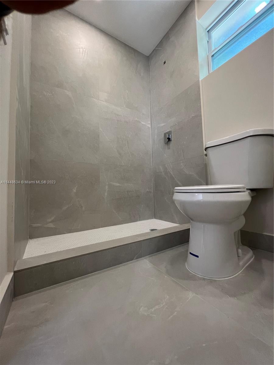 Pinewood Miami, FL 33167 - Photo 29 of 31 a bathroom with a toilet a sink and a shower