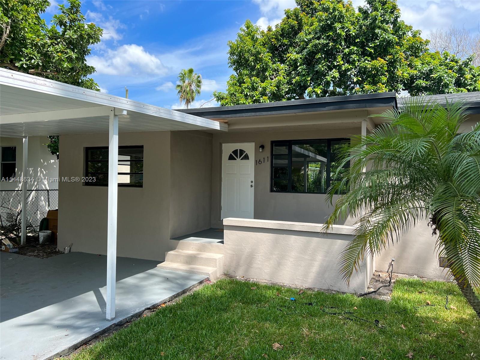 Pinewood Miami, FL 33167 - Photo 5 of 31 a view of backyard with potted plants and floor to ceiling window