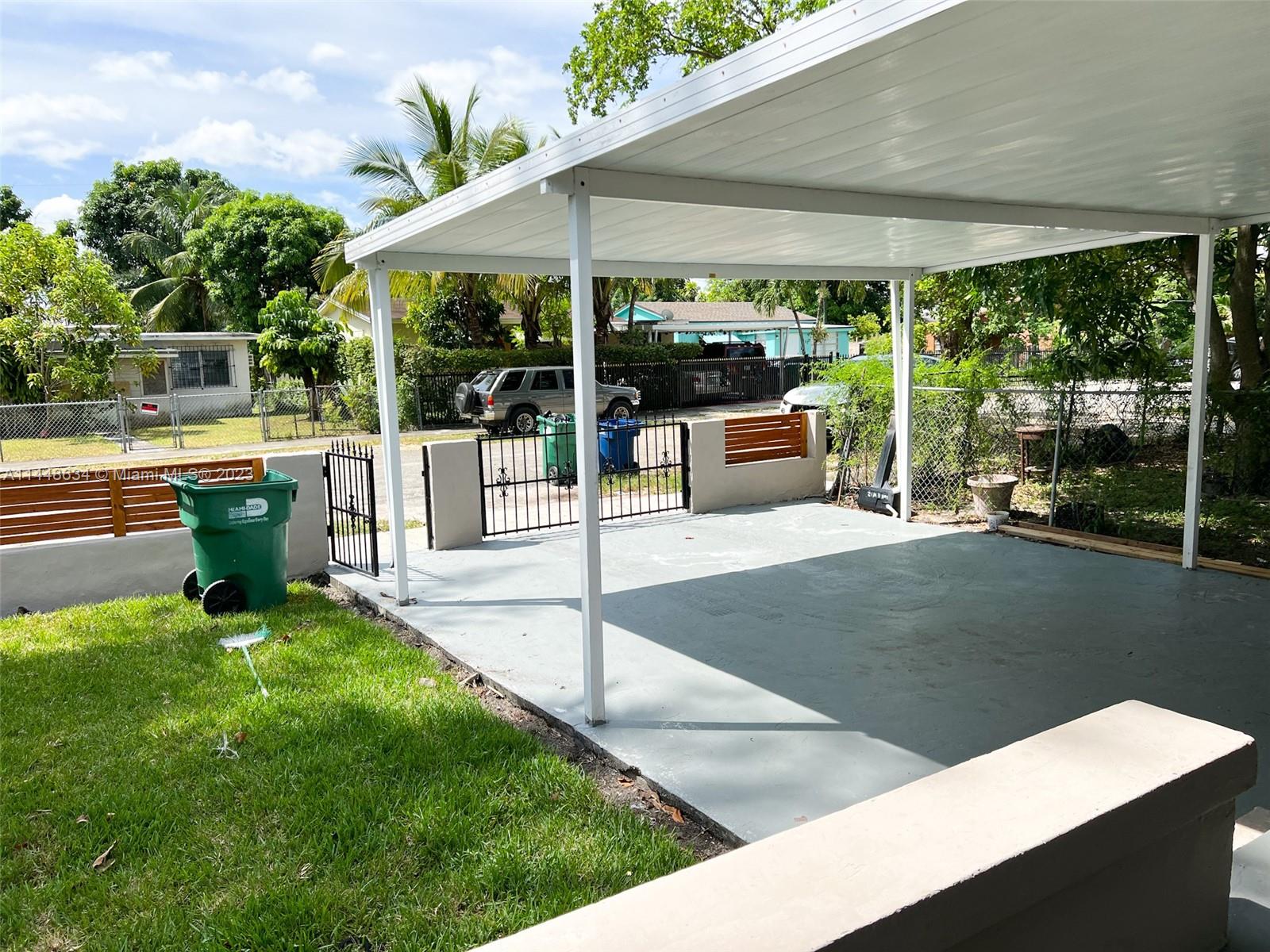 Pinewood Miami, FL 33167 - Photo 7 of 31 a view of a patio with table and chairs potted plants with floor to ceiling window and potted plants