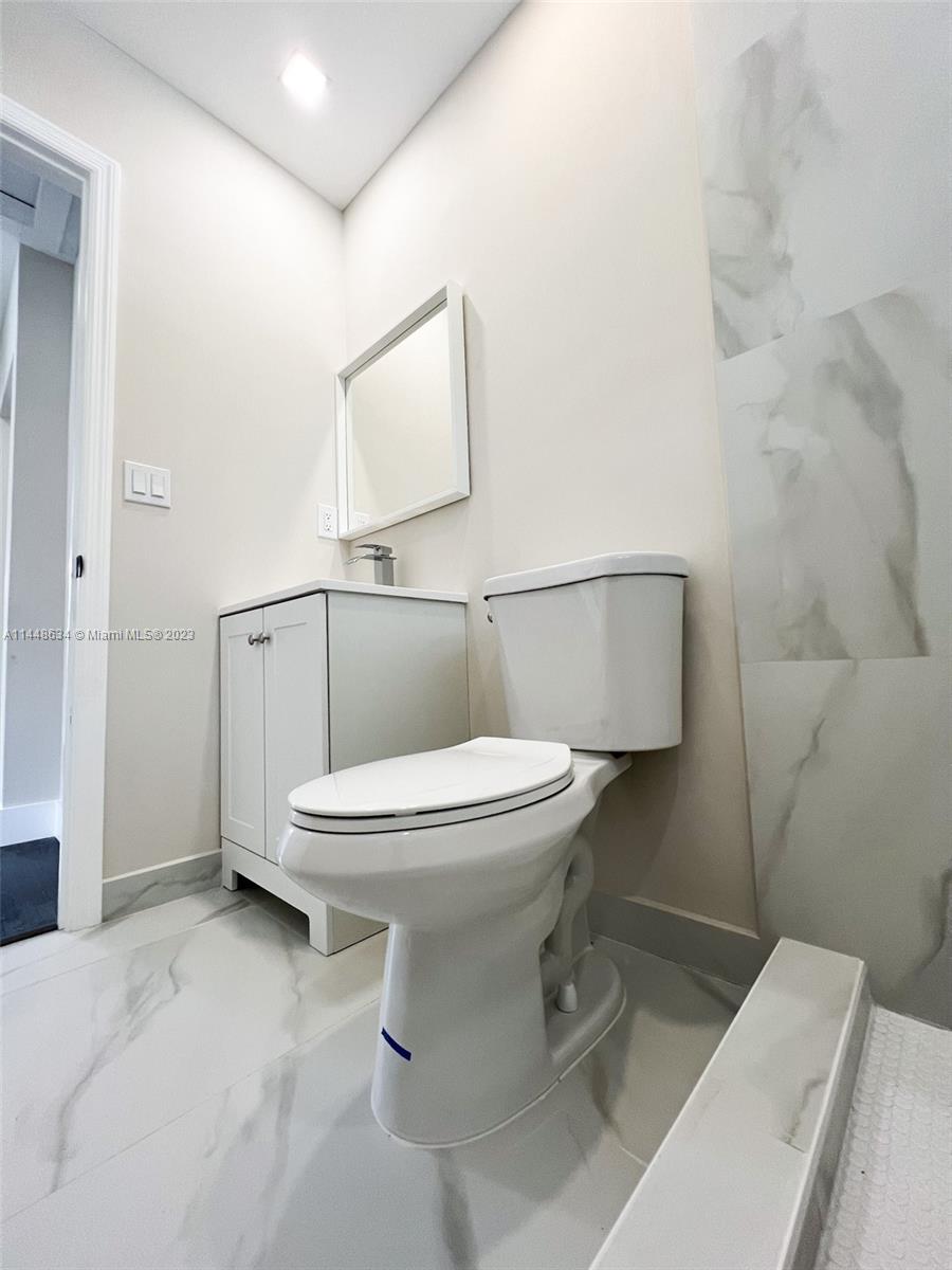 Pinewood Miami, FL 33167 - Photo 10 of 31 a white toilet sitting next to a bathroom sink