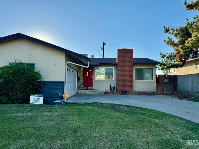 a front view of house with yard and outdoor seating