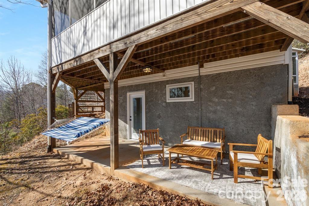 56 Great Horned Owl Road Candler, NC 28715 - Photo 27 of 32 a view of backyard with wooden deck and a patio