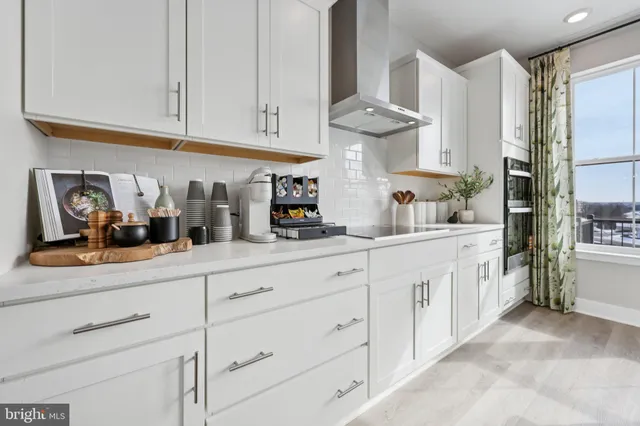 a kitchen with white cabinets and a sink