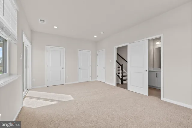 a view of a big room with closet and windows