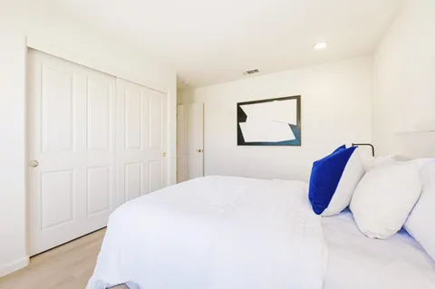 a bedroom with a bed and a couch
